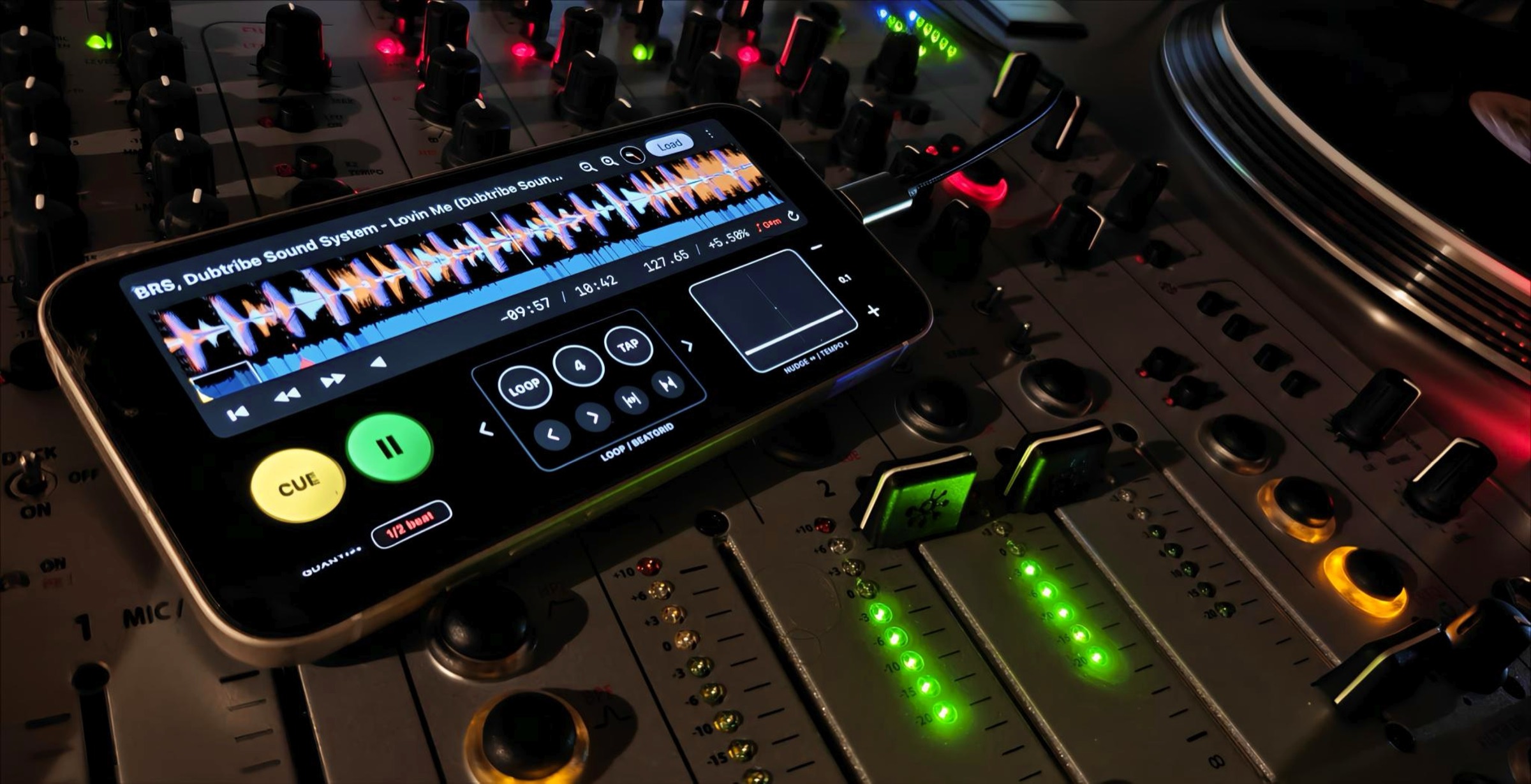 Deck beside glowing mixer channel meters